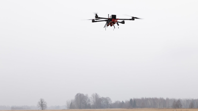 A drone flies over a field