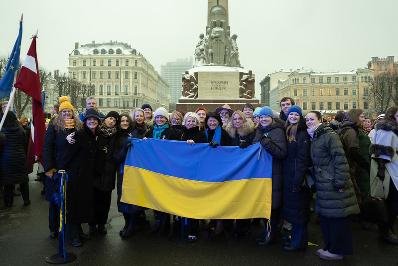  Members of the Diplomatic Choir holding the Ukrainian flag at the Freedom Monument